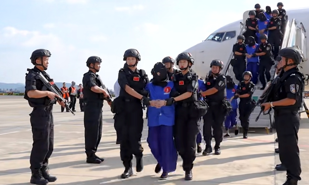 Chinese police officers escort 20 key members of telecom and online fraud criminal gangs back to China from Myanmar in this screenshot of a footage released by the Ministry of Public Security on September 29, 2024.