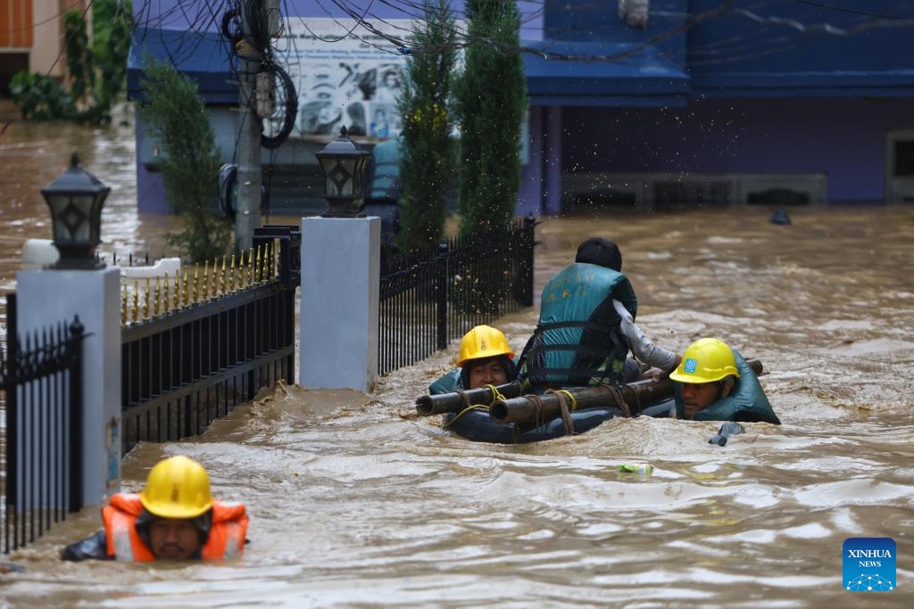 Rescuers evacuate a resident trapped in a flooded neighborhood in Lalitpur, Nepal, Sept. 28, 2024. Floods and landslides triggered by incessant rainfalls in Nepal have claimed at least 59 lives and injured 36 others by Saturday afternoon, police said. (Photo: Xinhua)