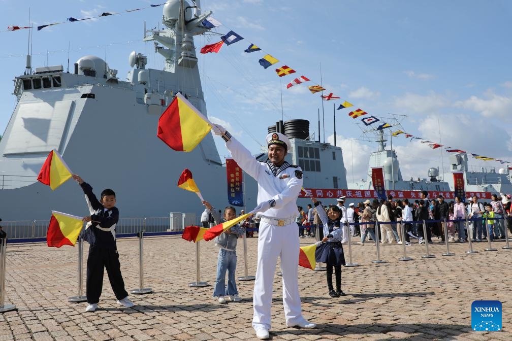 Children learn flag language during an open day activity of Chinese naval ships at a port in Qingdao of east China's Shandong Province, Oct. 1, 2024. (Photo: Xinhua)