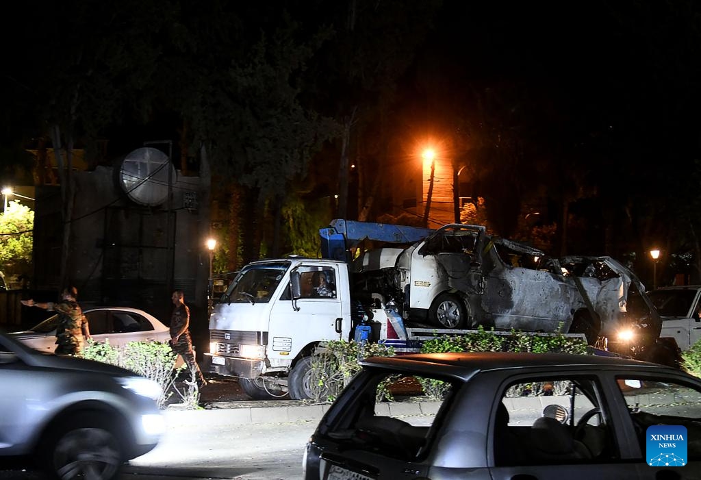 A damaged car is seen as a result of an Israeli aerial assault in the Mazzeh Villas area west of Damascus, Syria, Oct. 1, 2024. According to the Syrian Defense Ministry, the attack have resulted in the deaths of three civilians and injuries to nine others. (Photo: Xinhua)