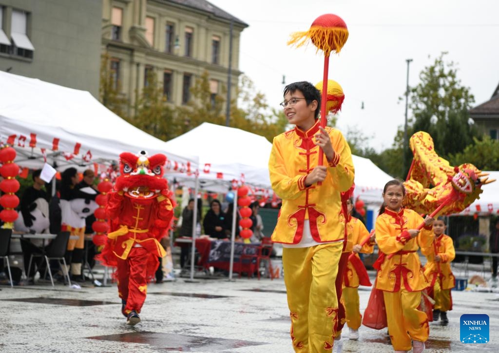 People perform Chinese lions and dragons dancing during a cultural event themed Meet China: Celebrating the 75th Anniversary of the Founding of the People's Republic of China at Waisenhaus Square in Bern, the capital of Switzerland, Sept. 27, 2024. (Photo: Xinhua)