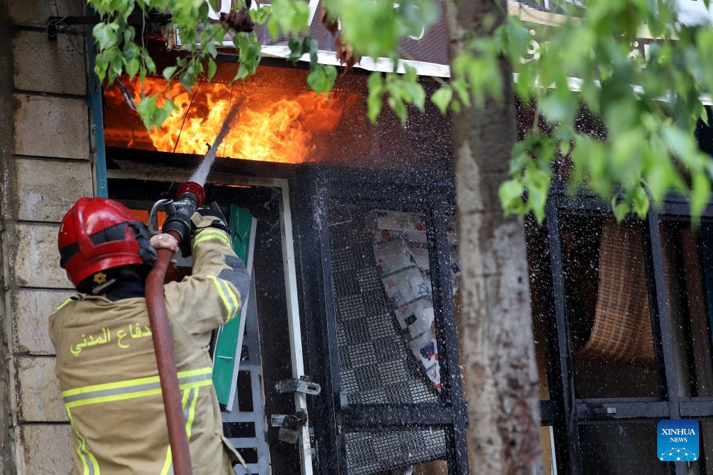 A firefighter tries to extinguish a fire after Israeli airstrikes in the southern suburbs of Beirut, Lebanon, Sept. 28, 2024. (Photo: Xinhua)