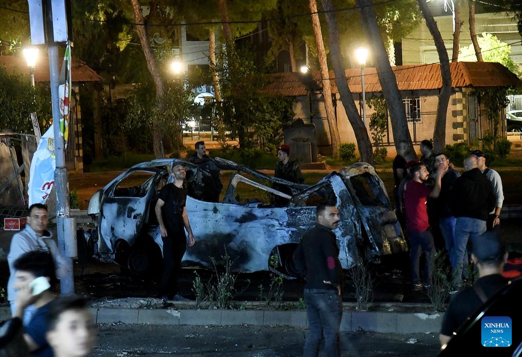 A damaged car is seen as a result of an Israeli aerial assault in the Mazzeh Villas area west of Damascus, Syria, Oct. 1, 2024. According to the Syrian Defense Ministry, the attack have resulted in the deaths of three civilians and injuries to nine others. (Photo: Xinhua)