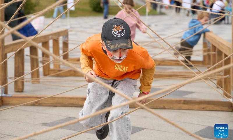 Children take part in a rope labyrinth game during the Tiger Day event in Vladivostok, Russia, Sept. 29, 2024. Since the year 2000, the last Sunday of September has been the Tiger Day in Russia. On Sunday, the city of Vladivostok hosted a variety of colorful events to promote awareness of protecting tigers and other wild animals. Photo: Xinhua