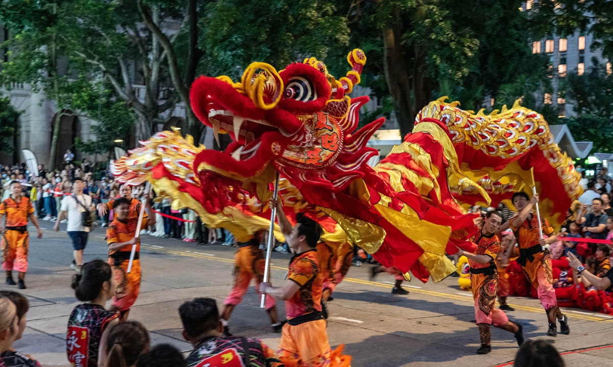 People perform a traditional Chinese dragon dance at an event celebrating the upcoming 75th anniversary of the founding of the People's Republic of China in the Central district of China's Hong Kong Special Administrative Region on September 29, 2024. Photo: VCG