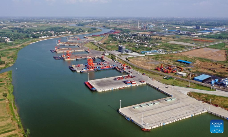 An aerial drone photo shows Zhoukou Central Port in Zhoukou, central China's Henan Province, June 28, 2022. Strategically positioned in central part of the country, Henan has been serving as a national hub of transporation for ages. The past decades saw the province building a modern transportation network consisting air flights, railways, highways, water channels and all sorts of ports. It is now rapidly extending its role to areas of cross-border logistics, investment, and trade to facilitate the dual circulation of domestic and international markets. Photo: Xinhua