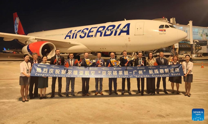 Staff members pose for a group photo after Air Serbia flight JU988 landed at the Guangzhou Baiyun International Airport in Guangzhou, south China's Guangdong Province, Sept. 30, 2024. Photo: Xinhua