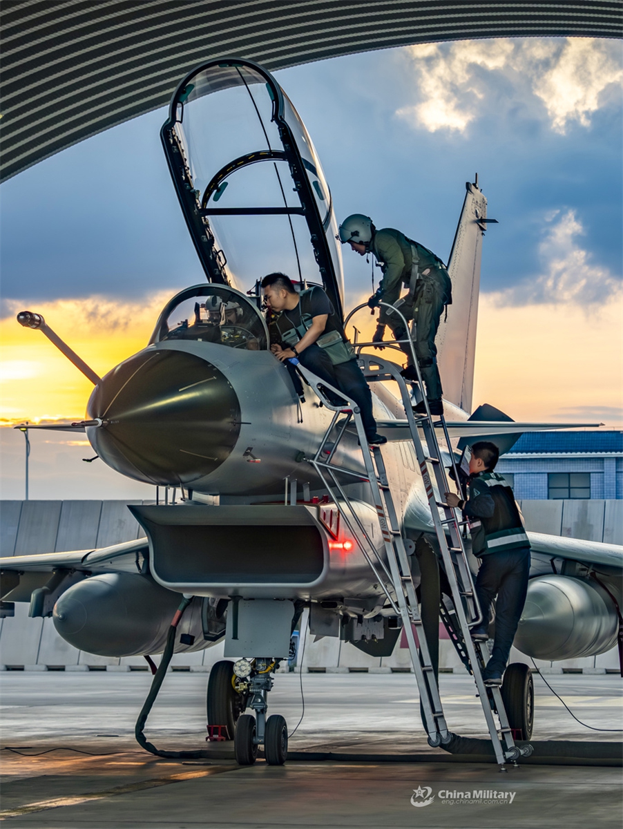 Maintenance men assigned to an aviation brigade under the Chinese PLA Air Force conduct pre-flight inspections on a fighter jet prior to a flight training exercise in late July, 2024. (eng.chinamil.com.cn/Photo by Shang Jieyan)