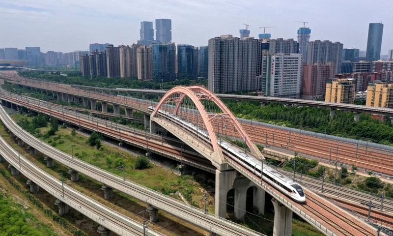 A bullet train runs on a bridge in Zhengzhou, central China's Henan Province, May 30, 2024. Strategically positioned in central part of the country, Henan has been serving as a national hub of transporation for ages. The past decades saw the province building a modern transportation network consisting air flights, railways, highways, water channels and all sorts of ports. It is now rapidly extending its role to areas of cross-border logistics, investment, and trade to facilitate the dual circulation of domestic and international markets. Photo: Xinhua