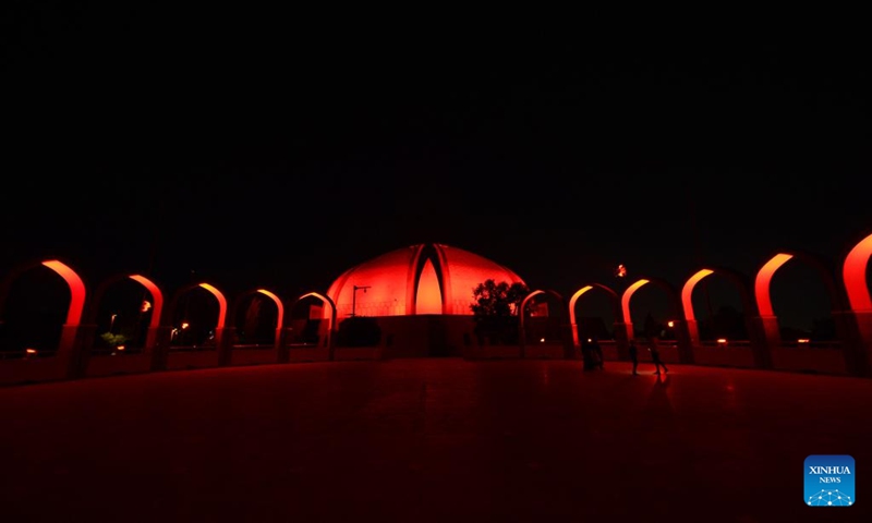 This photo taken on Sept. 30, 2024 shows the National Monument illuminated in red color to mark the upcoming 75th anniversary of the founding of the People's Republic of China in Islamabad, capital of Pakistan. Photo: Xinhua