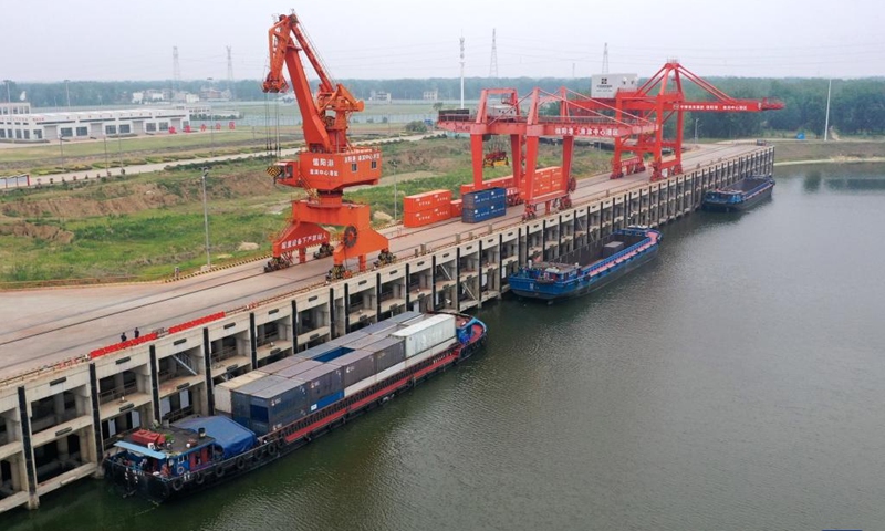 A drone photo shows cargo vessels berthed at a port in Huaibin County, central China's Henan Province, June 5, 2024. Strategically positioned in central part of the country, Henan has been serving as a national hub of transporation for ages. The past decades saw the province building a modern transportation network consisting air flights, railways, highways, water channels and all sorts of ports. It is now rapidly extending its role to areas of cross-border logistics, investment, and trade to facilitate the dual circulation of domestic and international markets. Photo: Xinhua