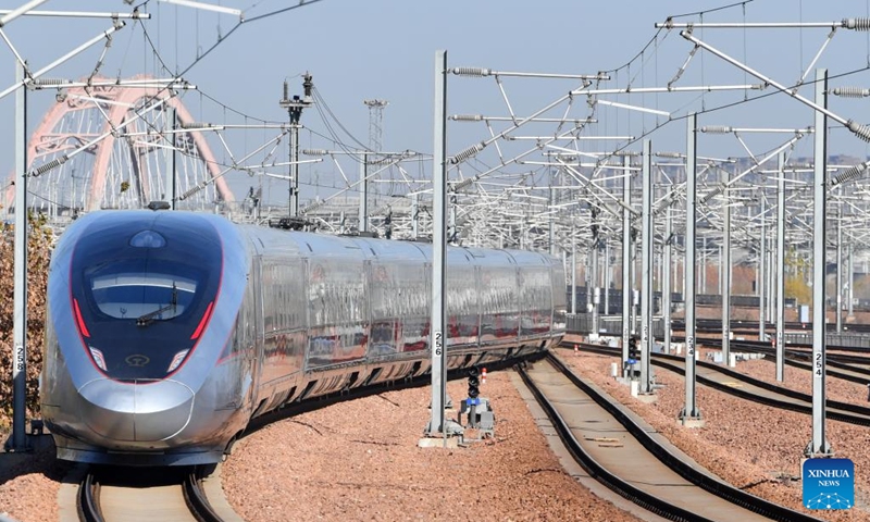 A bullet train departs from Zhengzhou East Railway Station in Zhengzhou, central China's Henan Province, Dec. 8, 2023. Strategically positioned in central part of the country, Henan has been serving as a national hub of transporation for ages. The past decades saw the province building a modern transportation network consisting air flights, railways, highways, water channels and all sorts of ports. It is now rapidly extending its role to areas of cross-border logistics, investment, and trade to facilitate the dual circulation of domestic and international markets. Photo: Xinhua