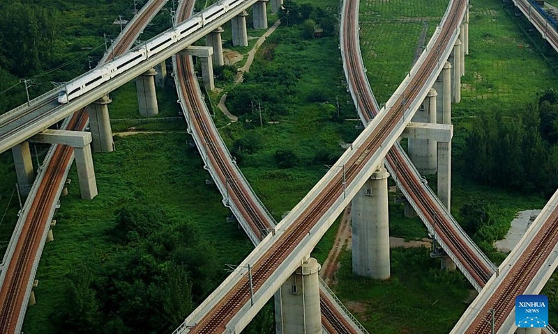 A bullet train runs on a bridge in Zhengzhou, central China's Henan Province, Aug. 17, 2017. Strategically positioned in central part of the country, Henan has been serving as a national hub of transporation for ages. The past decades saw the province building a modern transportation network consisting air flights, railways, highways, water channels and all sorts of ports. It is now rapidly extending its role to areas of cross-border logistics, investment, and trade to facilitate the dual circulation of domestic and international markets. Photo: Xinhua