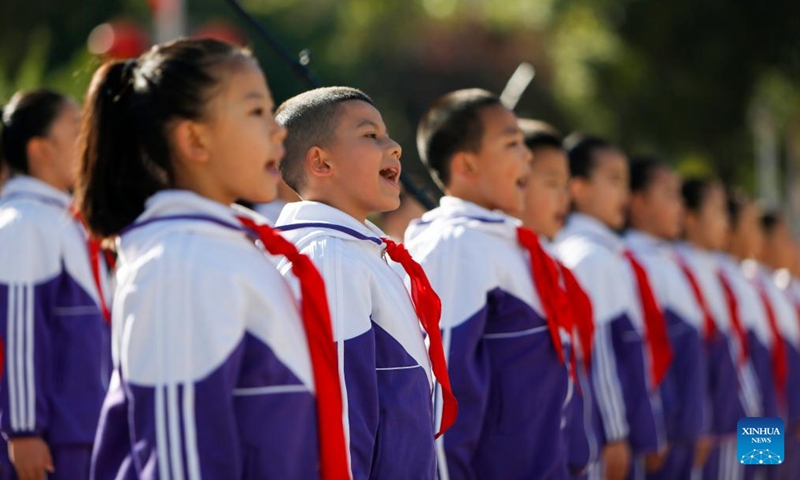 Members of the Chinese Young Pioneers sing during a mourning ritual at the People's Square in Urumqi, northwest China's Xinjiang Uygur Autonomous Region, Sept. 30, 2024. (Photo: Xinhua)