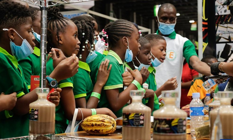 Children enjoy chocolate during the 9th National Cocoa and Chocolate Day in Abidjan, Cote d'Ivoire, Sept. 28, 2024. The event was held in Abidjan from Sept. 28 to 30. (Photo: Xinhua)