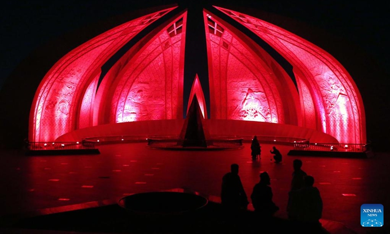 This photo taken on Sept. 30, 2024 shows the National Monument illuminated in red color to mark the upcoming 75th anniversary of the founding of the People's Republic of China in Islamabad, capital of Pakistan. Photo: Xinhua