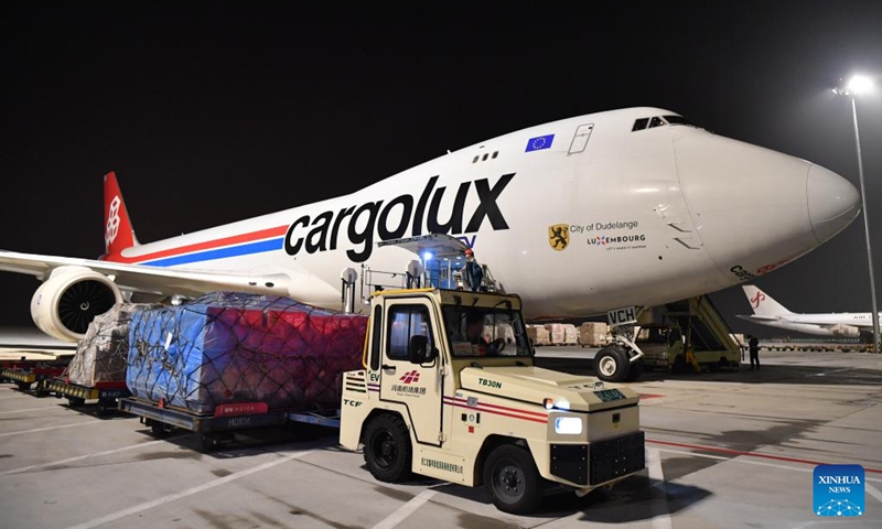 Airport staff members unload a cargo plane at Xinzheng International Airport in Zhengzhou, central China's Henan Province, Aug. 1, 2023. Strategically positioned in central part of the country, Henan has been serving as a national hub of transporation for ages. The past decades saw the province building a modern transportation network consisting air flights, railways, highways, water channels and all sorts of ports. It is now rapidly extending its role to areas of cross-border logistics, investment, and trade to facilitate the dual circulation of domestic and international markets. Photo: Xinhua