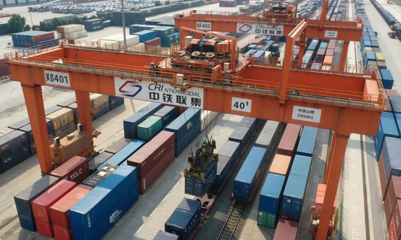 A drone photo shows a container being lifted at Zhoukou Central Port in Zhoukou, central China's Henan Province, Sept. 17, 2023. Strategically positioned in central part of the country, Henan has been serving as a national hub of transporation for ages. The past decades saw the province building a modern transportation network consisting air flights, railways, highways, water channels and all sorts of ports. It is now rapidly extending its role to areas of cross-border logistics, investment, and trade to facilitate the dual circulation of domestic and international markets. Photo: Xinhua