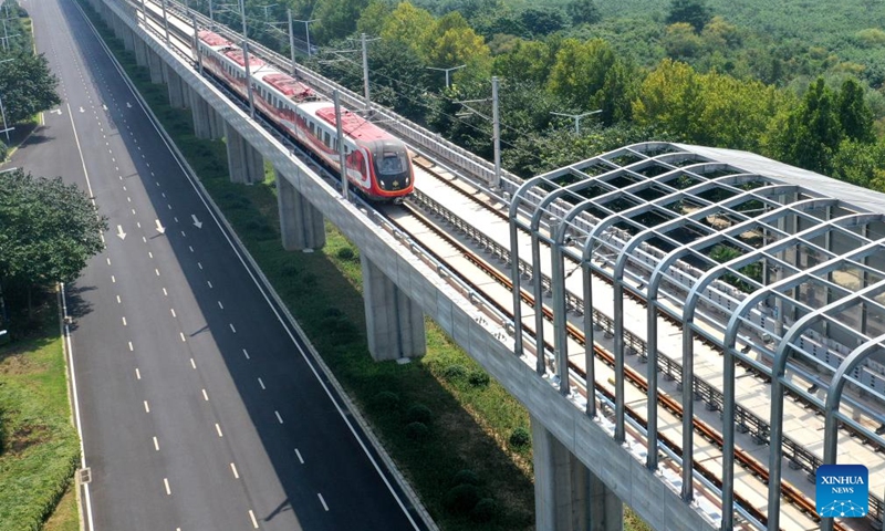 A drone photo shows an inter-city train in trial operation in Xuchang City, central China's Henan Province, Sept. 8, 2022. Strategically positioned in central part of the country, Henan has been serving as a national hub of transporation for ages. The past decades saw the province building a modern transportation network consisting air flights, railways, highways, water channels and all sorts of ports. It is now rapidly extending its role to areas of cross-border logistics, investment, and trade to facilitate the dual circulation of domestic and international markets. Photo: Xinhua