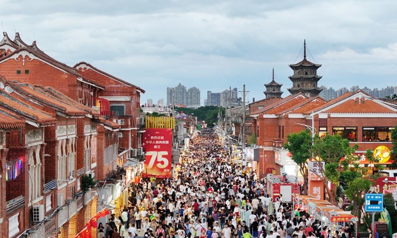 An aerial photo taken on Oct. 1, 2024 shows tourists visiting Xijie, an ancient street area, in Quanzhou, southeast China's Fujian Province. The National Day holiday period, which runs from Oct. 1 to Oct. 7 this year, is a peak travel and tourism season in China. (Photo by Zhang Jiuqiang/Xinhua)