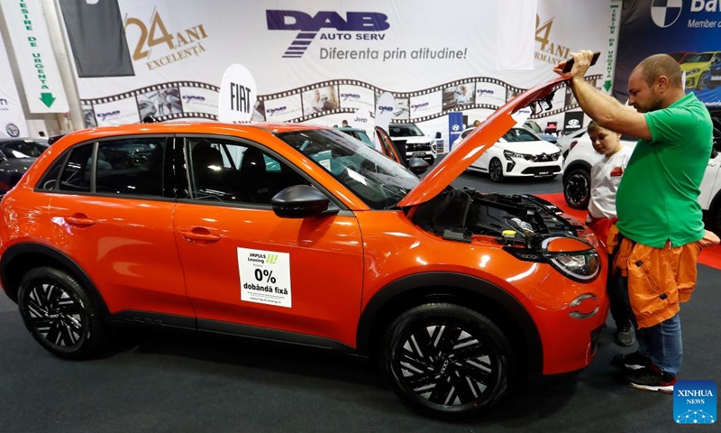 A visitor views a Fiat 600 car during the first day of Bucharest Auto Show & Accessories (SAB) in Bucharest, Romania, Oct. 1, 2024. Dozens of conventional, hybrid and electric vehicles, and over 600 brands from the fields of equipment, self-service car washes, parts, accessories, and services are on display at the exhibition until Oct. 6. (Photo by Cristian Cristel/Xinhua)