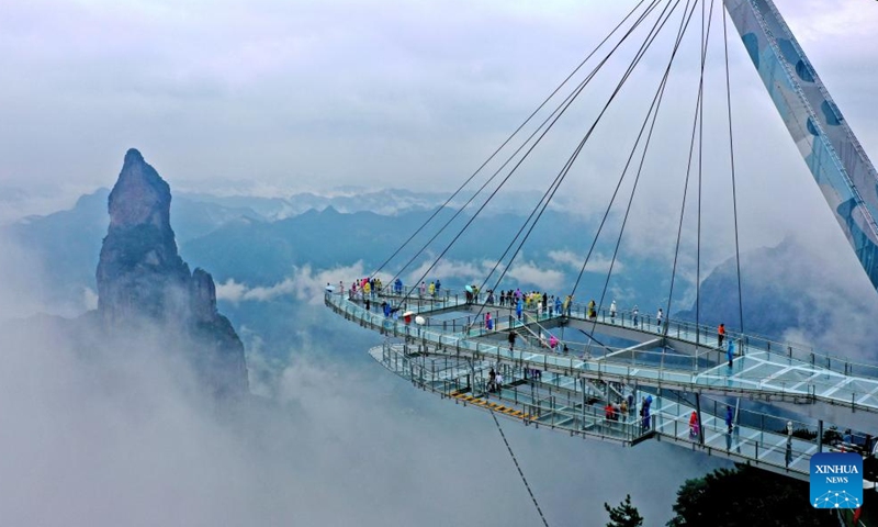 An aerial drone photo taken on Oct. 2, 2024 shows tourists visiting the Shenxianju scenery spot in Taizhou, east China's Zhejiang Province. The National Day holiday period, which runs from Oct. 1 to Oct. 7 this year, is a peak travel and tourism season in China. (Photo by Wang Huabin/Xinhua)