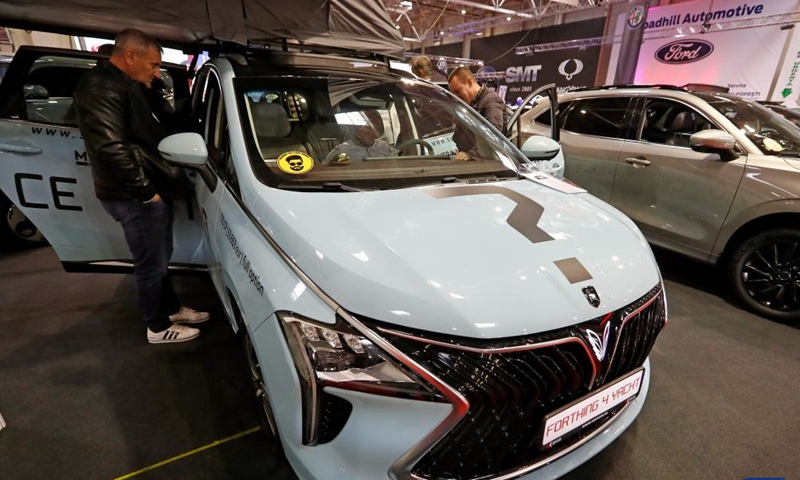 Visitors view a Forthing 4 Yacht car from Chinese automaker Dongfeng during the first day of Bucharest Auto Show & Accessories (SAB) in Bucharest, Romania, Oct. 1, 2024. Dozens of conventional, hybrid and electric vehicles, and over 600 brands from the fields of equipment, self-service car washes, parts, accessories, and services are on display at the exhibition until Oct. 6. (Photo by Cristian Cristel/Xinhua)