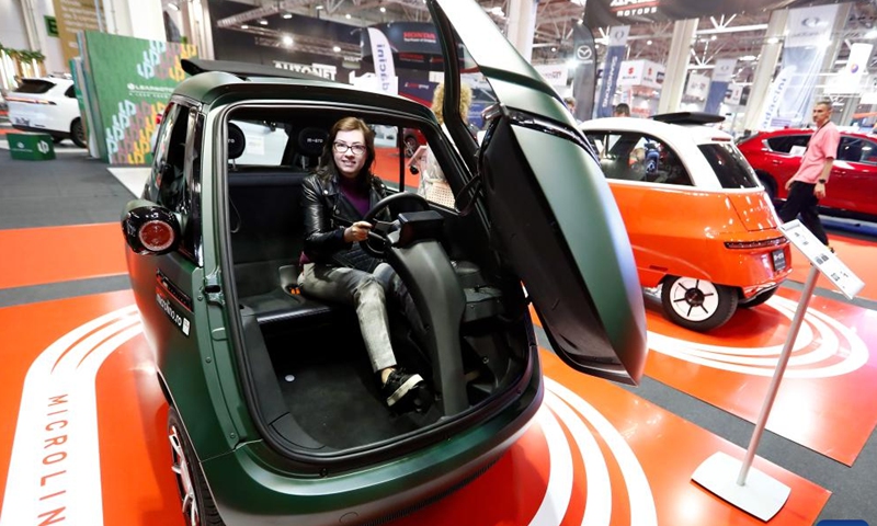 A visitor poses for photos inside a Microlino car during the first day of Bucharest Auto Show & Accessories (SAB) in Bucharest, Romania, Oct. 1, 2024. Dozens of conventional, hybrid and electric vehicles, and over 600 brands from the fields of equipment, self-service car washes, parts, accessories, and services are on display at the exhibition until Oct. 6. (Photo by Cristian Cristel/Xinhua)