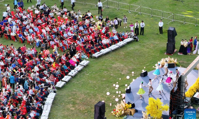 An aerial drone photo shows visitors watching an open-air concert in Shuangqiao Town, Wuming District of Nanning City, south China's Guangxi Zhuang Autonomous Region, Oct. 1, 2024. The National Day holiday period, which runs from Oct. 1 to Oct. 7 this year, is a peak travel and tourism season in China. (Photo by Yu Xiangquan/Xinhua)