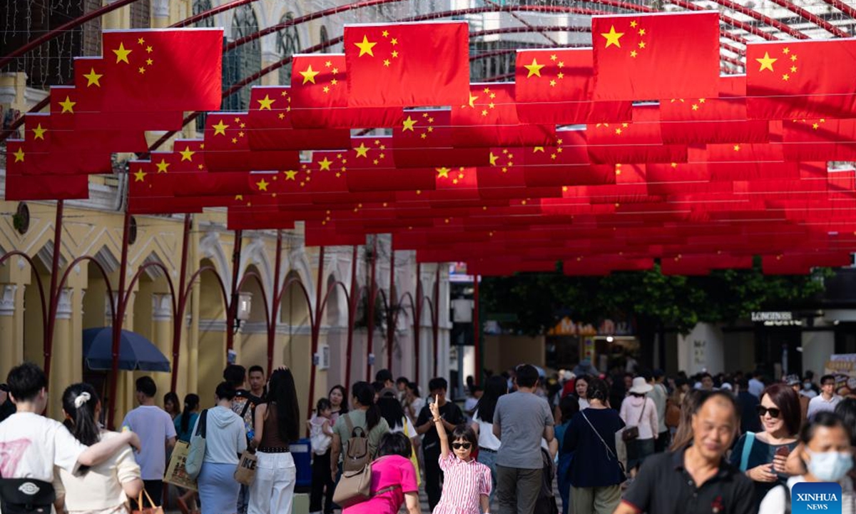 Tourists visit the Senado Square in Macao, south China, Oct. 1, 2024. Various events and activities were held here to celebrate the 75th anniversary of the founding of the People's Republic of China. (Xinhua/Cheong Kam Ka)