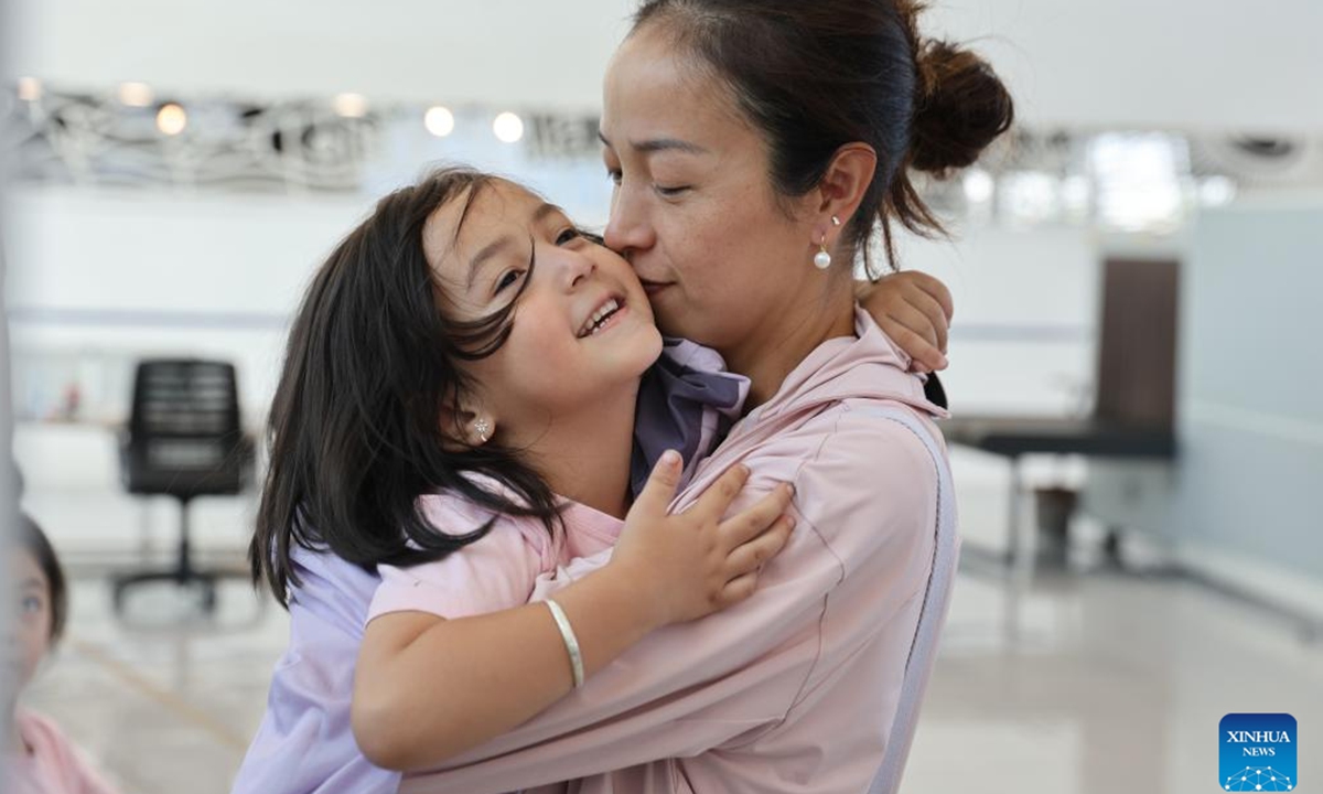 A girl evacuated from Lebanon embraces her mother at the Port of Limassol, Cyprus, on Oct. 1, 2024. (Xinhua/Li Jing)