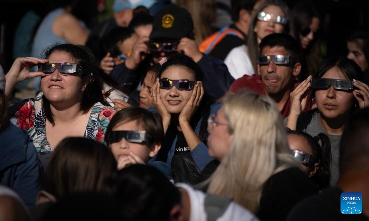 People observe an annular solar eclipse in Buenos Aires, capital of Argentina, on Oct. 2, 2024. (Photo by Martin Zabala/Xinhua)