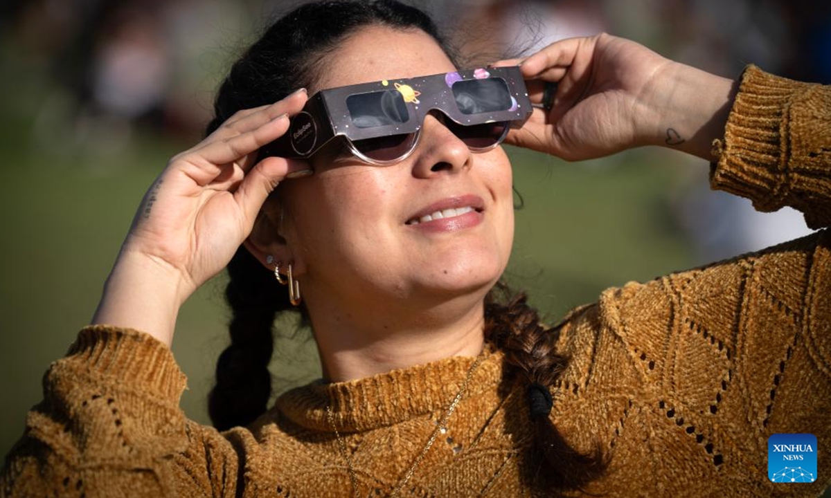 A woman observes an annular solar eclipse in Buenos Aires, capital of Argentina, on Oct. 2, 2024. (Photo by Martin Zabala/Xinhua)