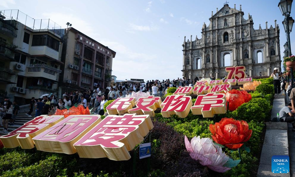 Tourists visit the Ruins of St. Paul's in Macao, south China, Oct. 1, 2024. Various events and activities were held here to celebrate the 75th anniversary of the founding of the People's Republic of China. (Xinhua/Cheong Kam Ka)