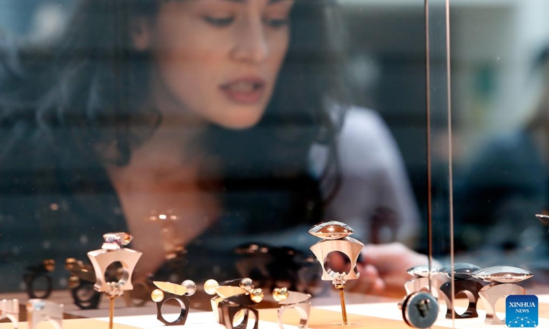 A visitor looks at concept creations during the fair of Romanian Jewelry Week at the National Library in Bucharest, Romania, Oct. 5, 2024. (Photo by Cristian Cristel/Xinhua)