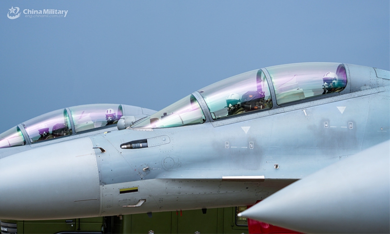 Pilots assigned to an aviation brigade with the air force under the Chinese PLA Southern Theater Command get ready to take off during a flight training exercise under complex meteorological conditions in early September, 2024. (eng.chinamil.com.cn/Photo by Zhao Yutong)