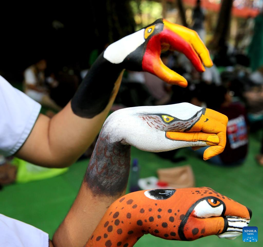 Students participate in a palm painting competition during the Wildlife Week celebration at Van Vihar National Park in Bhopal, the capital city of India's Madhya Pradesh state, Oct. 5, 2024. (Str/Xinhua)