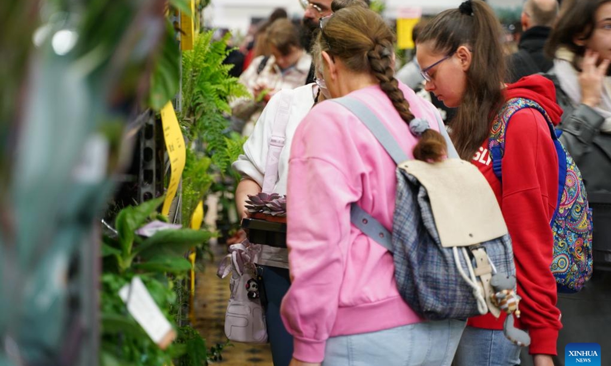 People select plants at the 6th Plant Festival in Lodz, Poland, Oct. 5, 2024. The two-day event kicked off here on Saturday, featuring direct sales from growers, showcasing household plants, gardening accessories, and eco-friendly products. (Photo: Xinhua)