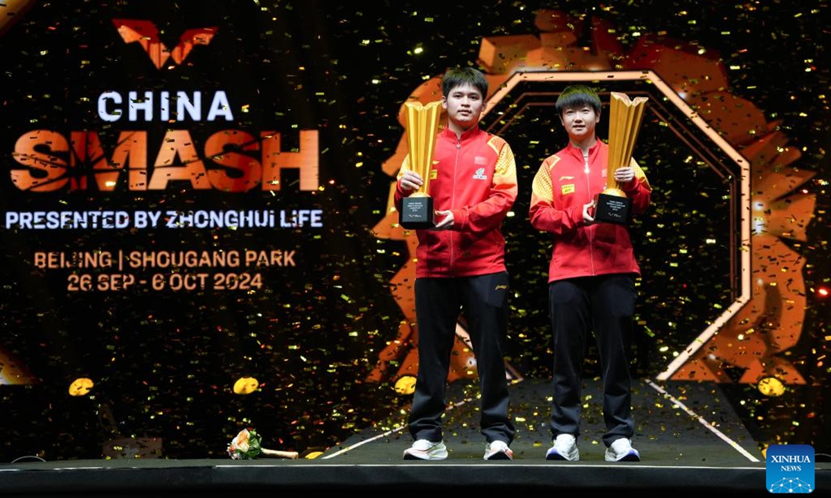 Men's singles winner Lin Shidong (L) of China and women's singles winner Sun Yingsha of China pose at 2024 World Table Tennis (WTT) China Smash in Beijing, China, Oct. 6, 2024. (Photo: Xinhua)