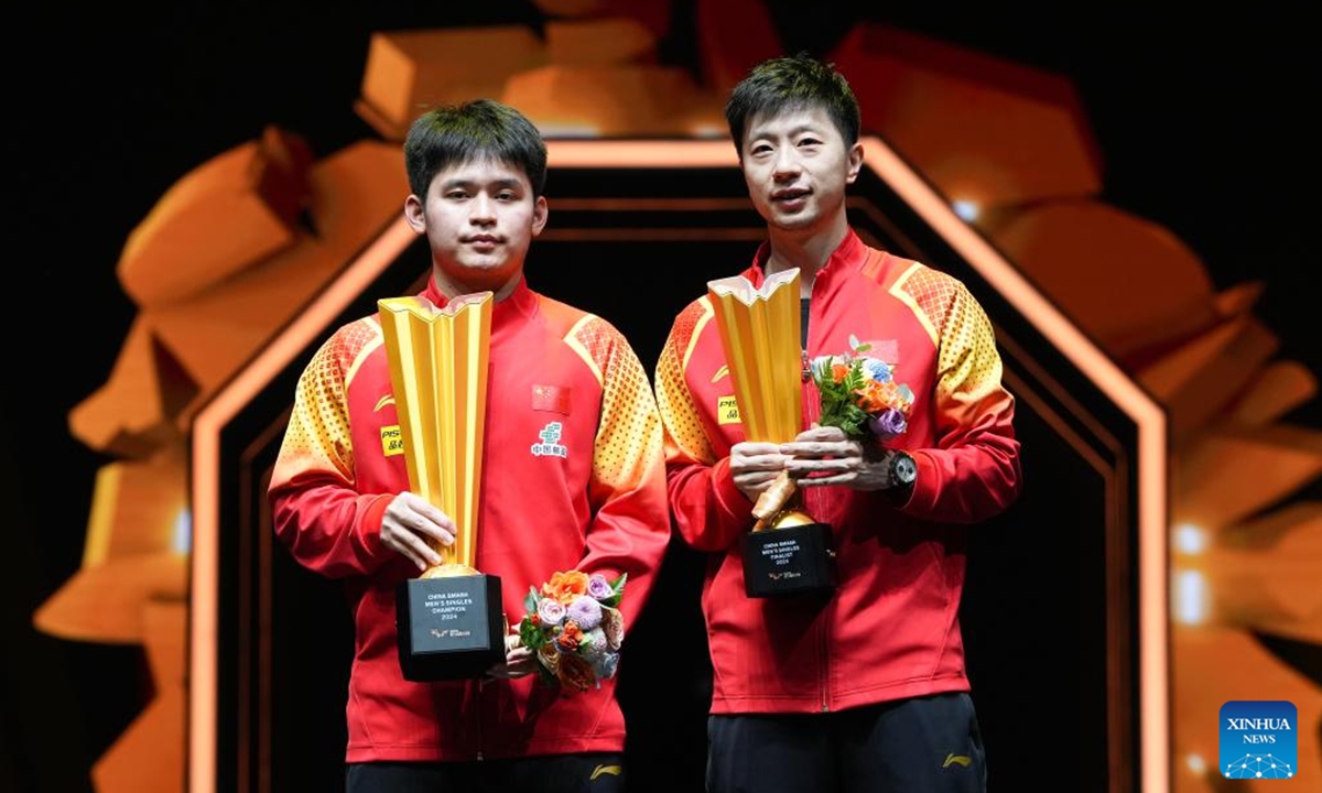 Winner Lin Shidong (L) and runner-up Ma Long of China pose during the awarding ceremony for the men's singles event at 2024 World Table Tennis (WTT) China Smash in Beijing, China, Oct. 6, 2024. (Photo: Xinhua)