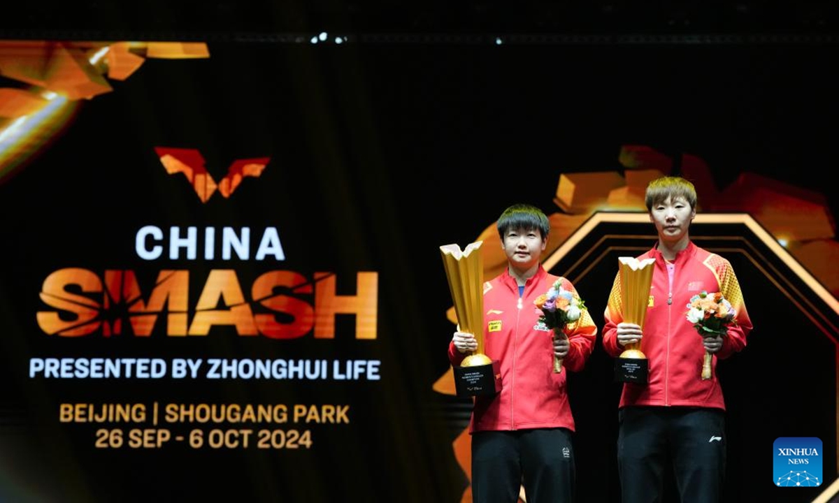 Winner Sun Yingsha (L) of China and runner-up Wang Manyu of China pose during the awarding ceremony for the women's singles event at 2024 World Table Tennis (WTT) China Smash in Beijing, China, Oct. 6, 2024. (Photo: Xinhua)