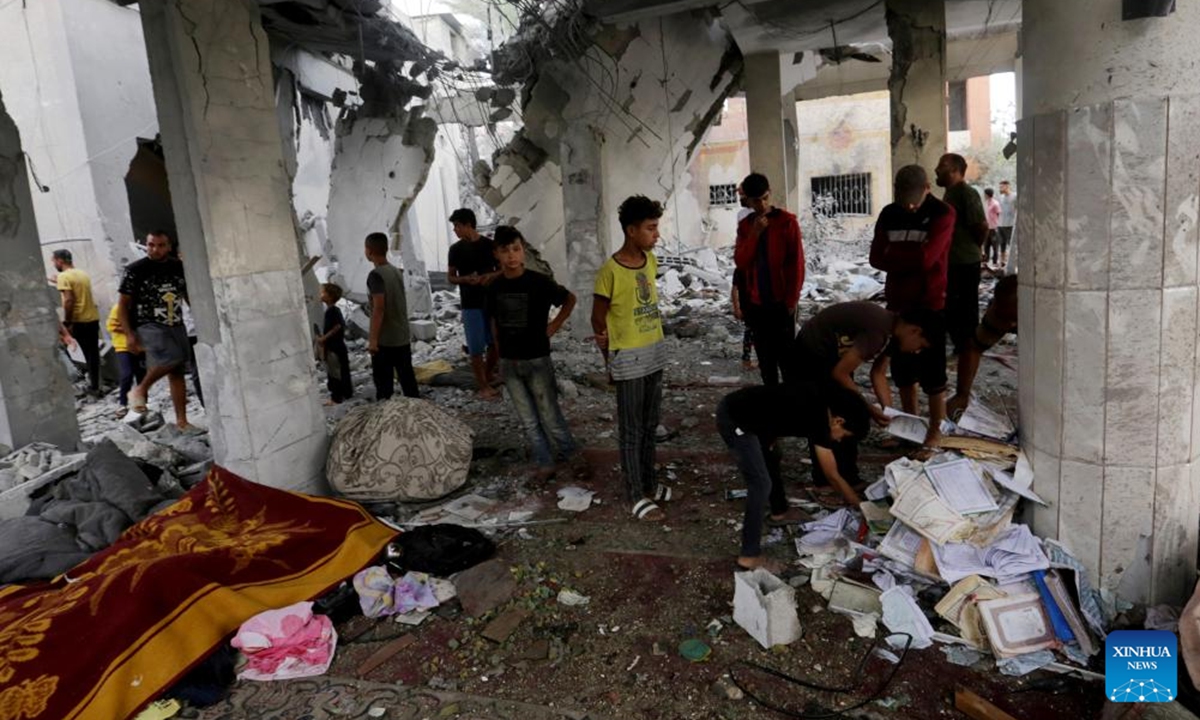 Palestinians check a destroyed mosque after it was attacked by the Israeli army in the city of Deir al-Balah in central Gaza Strip, on Oct. 6, 2024. At least 24 Palestinians were killed and 93 others wounded during Israel's bombing of a mosque and a school in the central Gaza Strip on Sunday, media reports said. (Photo: Xinhua)