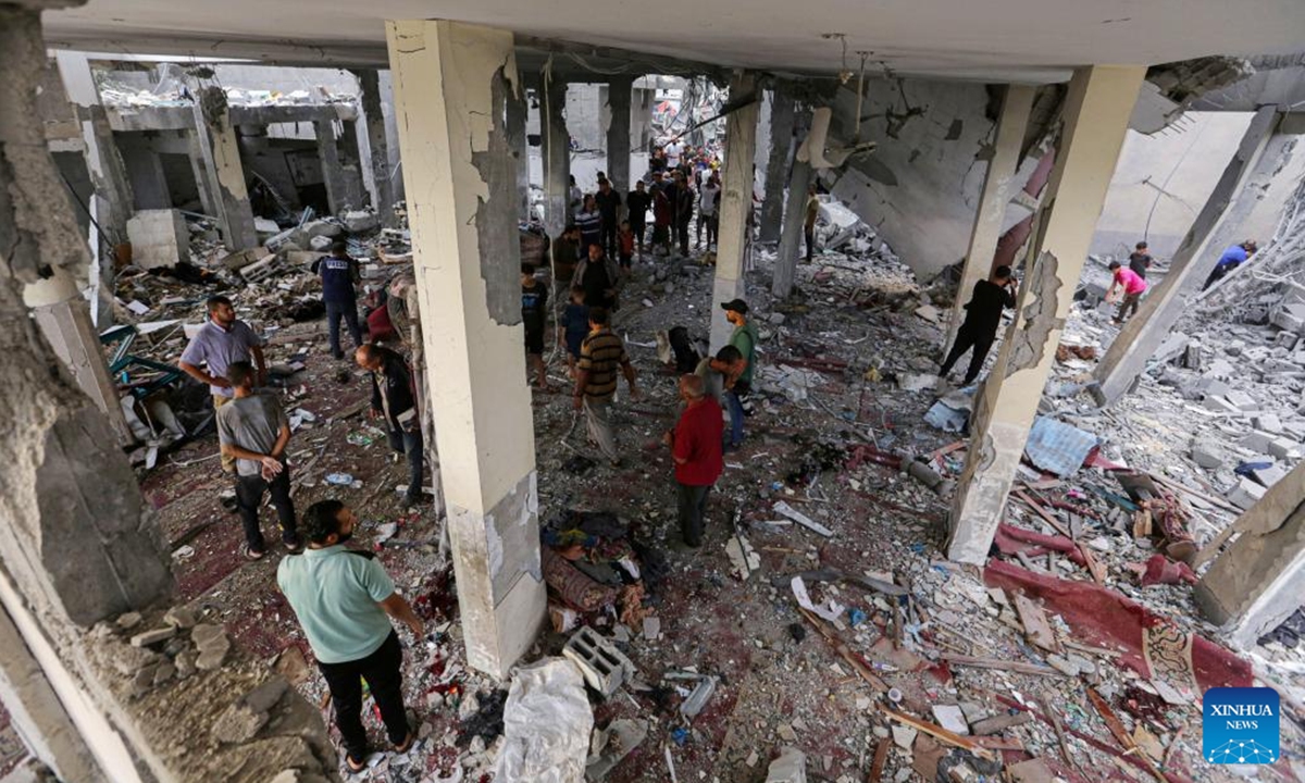 Palestinians check a destroyed mosque after it was attacked by the Israeli army in the city of Deir al-Balah in central Gaza Strip, on Oct. 6, 2024. At least 24 Palestinians were killed and 93 others wounded during Israel's bombing of a mosque and a school in the central Gaza Strip on Sunday, media reports said. (Photo: Xinhua)