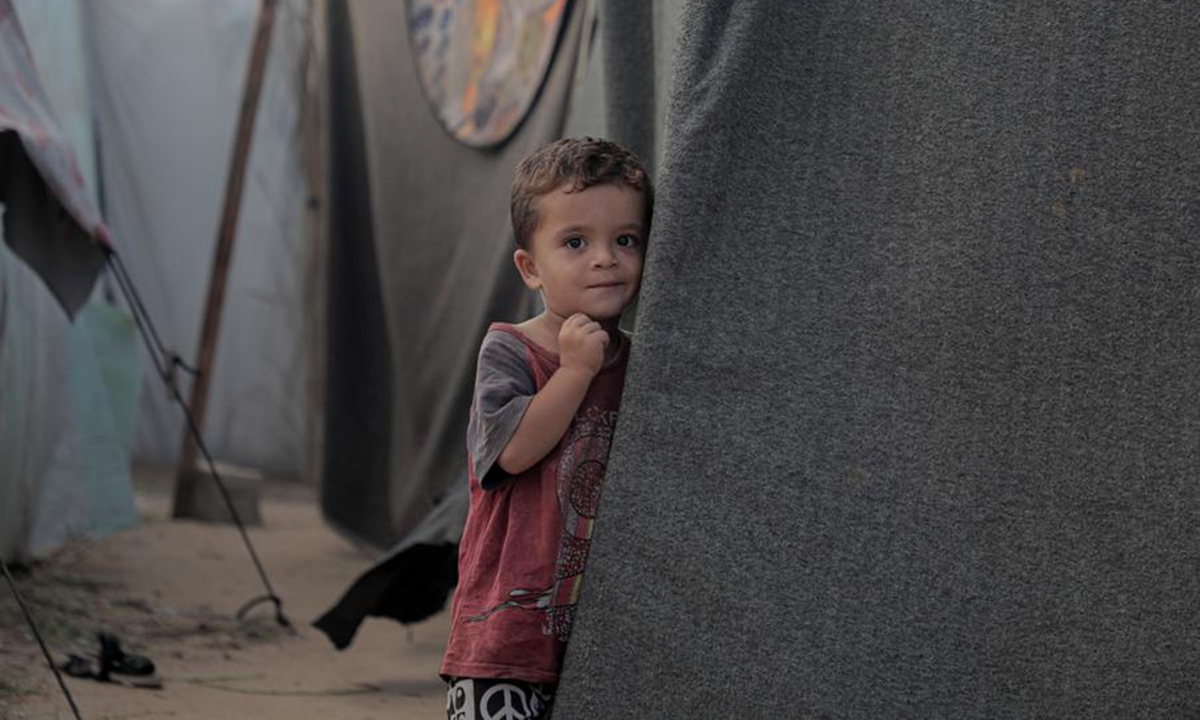 A Palestinian child is seen outside a tent at a displacement center in the city of Deir al-Balah in the central Gaza Strip, on Oct. 5, 2024. (Photo: Xinhua)