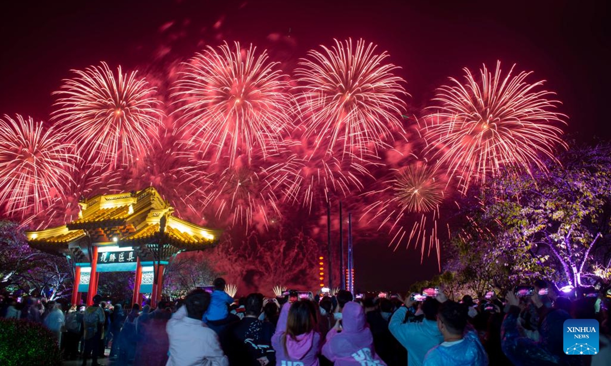 Tourists watch a firework show at the Yuantouzhu scenic spot of the Taihu Lake in Wuxi, east China's Jiangsu Province, Oct. 5, 2024. During the week-long National Day holiday starting on Oct. 1, Chinese people take a break to travel and enjoy leisure activities. People's increasing strong demand for diversified vacation options has given rise to more abundant and diverse cultural and tourism products in the tourism market during the holiday.  (Photo: Xinhua)