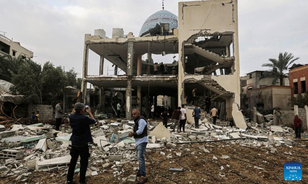 Palestinians check a destroyed mosque after it was attacked by the Israeli army in the city of Deir al-Balah in central Gaza Strip, on Oct. 6, 2024. At least 24 Palestinians were killed and 93 others wounded during Israel's bombing of a mosque and a school in the central Gaza Strip on Sunday, media reports said. (Photo: Xinhua)