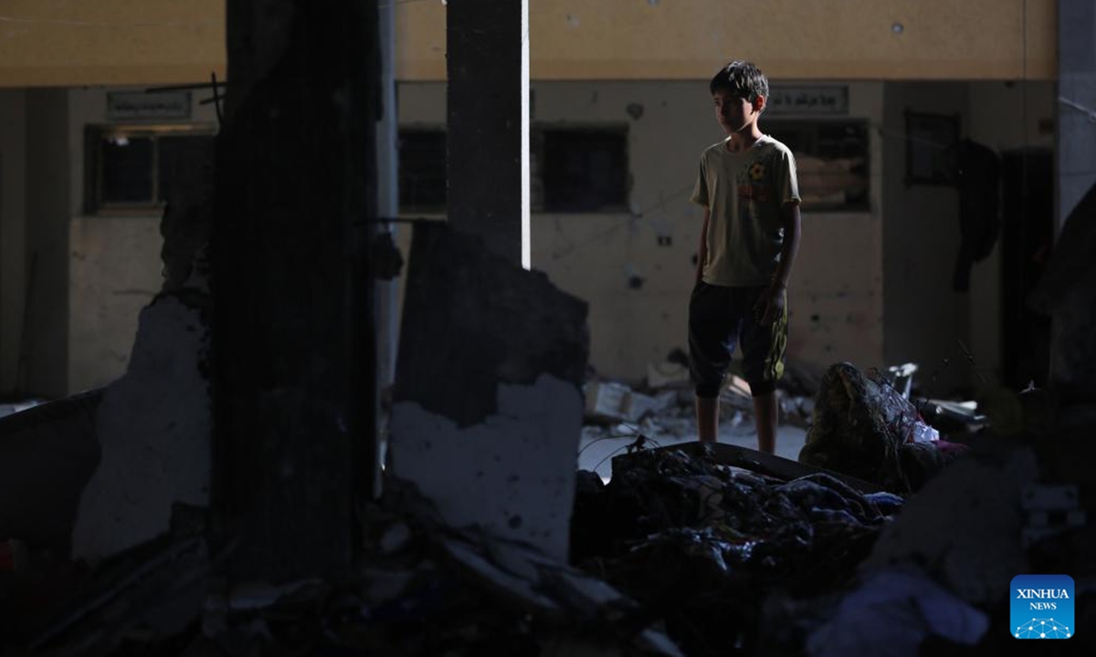 A Palestinian boy is seen at a school sheltering displaced people after it was attacked by the Israeli army in the city of Deir al-Balah in central Gaza Strip, on Oct. 6, 2024. At least 24 Palestinians were killed and 93 others wounded during Israel's bombing of a mosque and a school in the central Gaza Strip on Sunday, media reports said. (Photo: Xinhua)