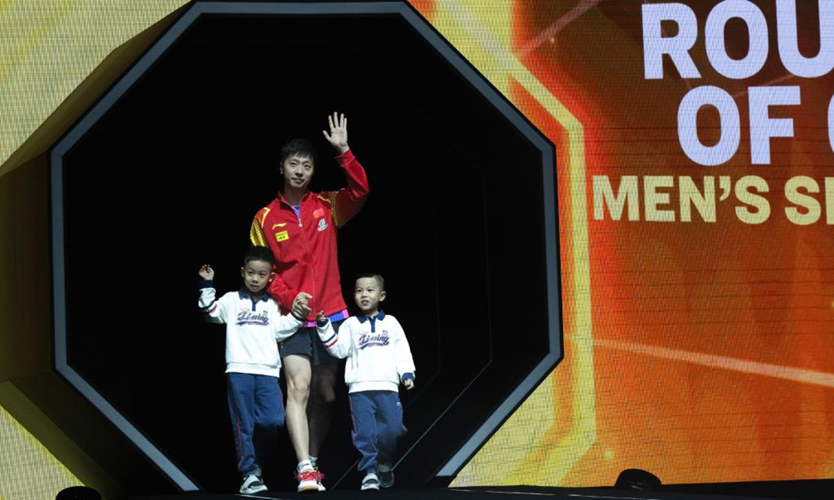 Ma Long of China walks into the court with his sons before the men's singles first round match at 2024 World Table Tennis (WTT) China Smash, Sept. 30, 2024. (Photo: Xinhua)