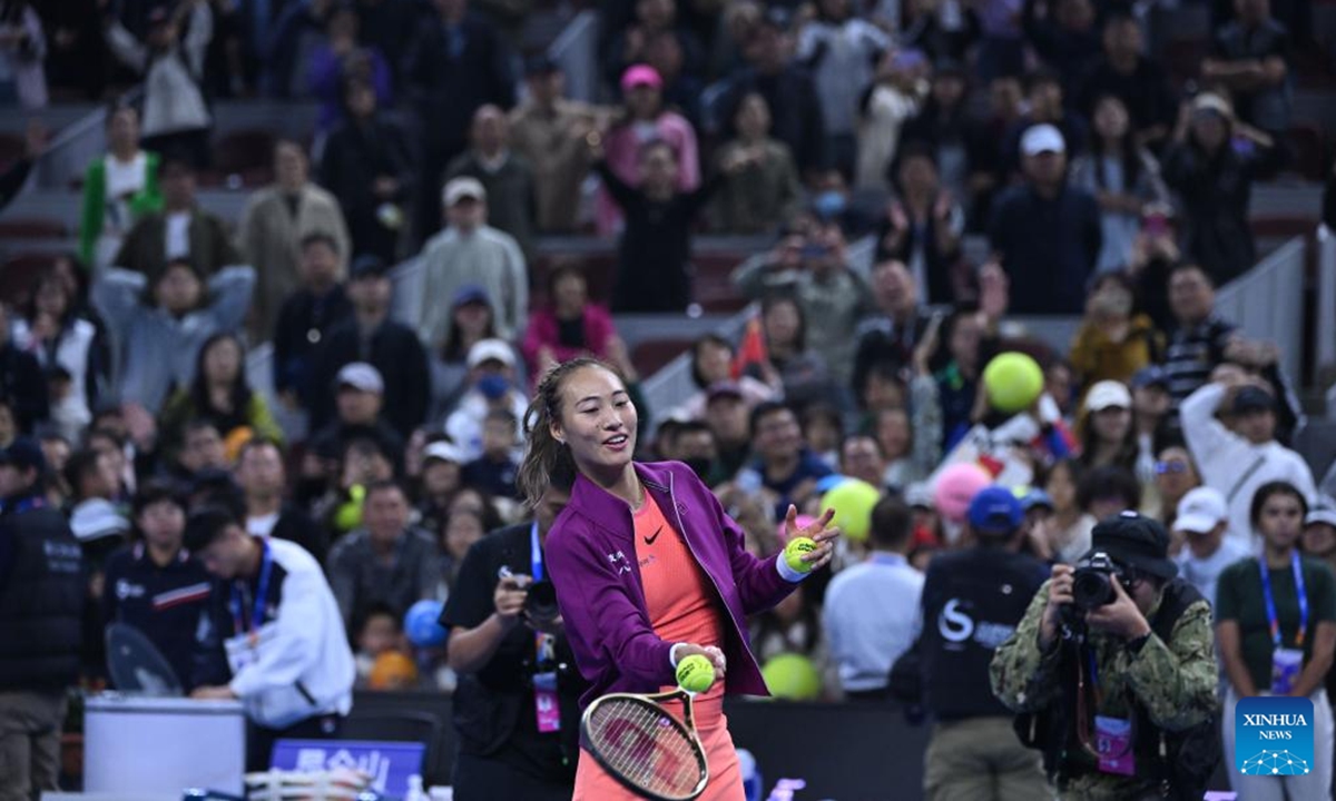 Zheng Qinwen sends signed balls after the women's singles quarterfinal match between Zheng Qinwen of China and Mirra Andreeva of Russia at the 2024 China Open tennis tournament in Beijing, China, Oct. 4, 2024.  (Photo: Xinhua)