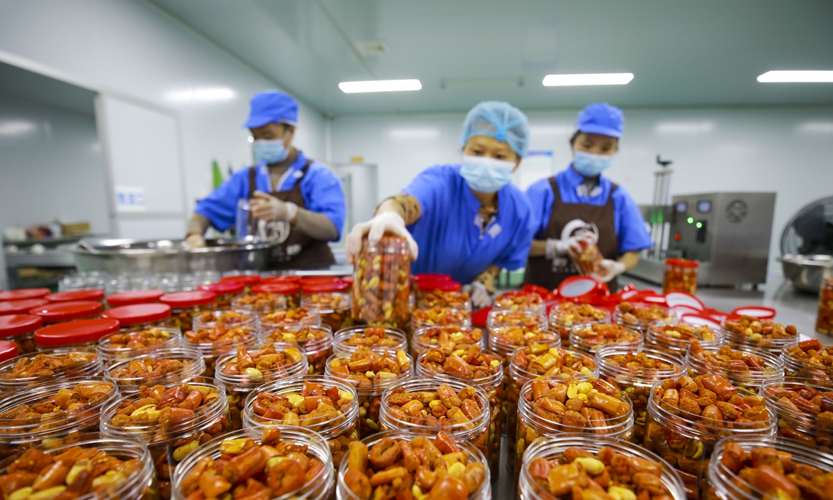 Workers make chili-based snacks in a food processing factory in Qianxi, Southwest China's Guizhou Province on October 8, 2024. In the first half of 2024, major food producers across the country achieved operating revenue of 4.3 trillion yuan ($609.53 billion), down slightly by 0.1 percent year-on-year, industry data showed. Photo: VCG